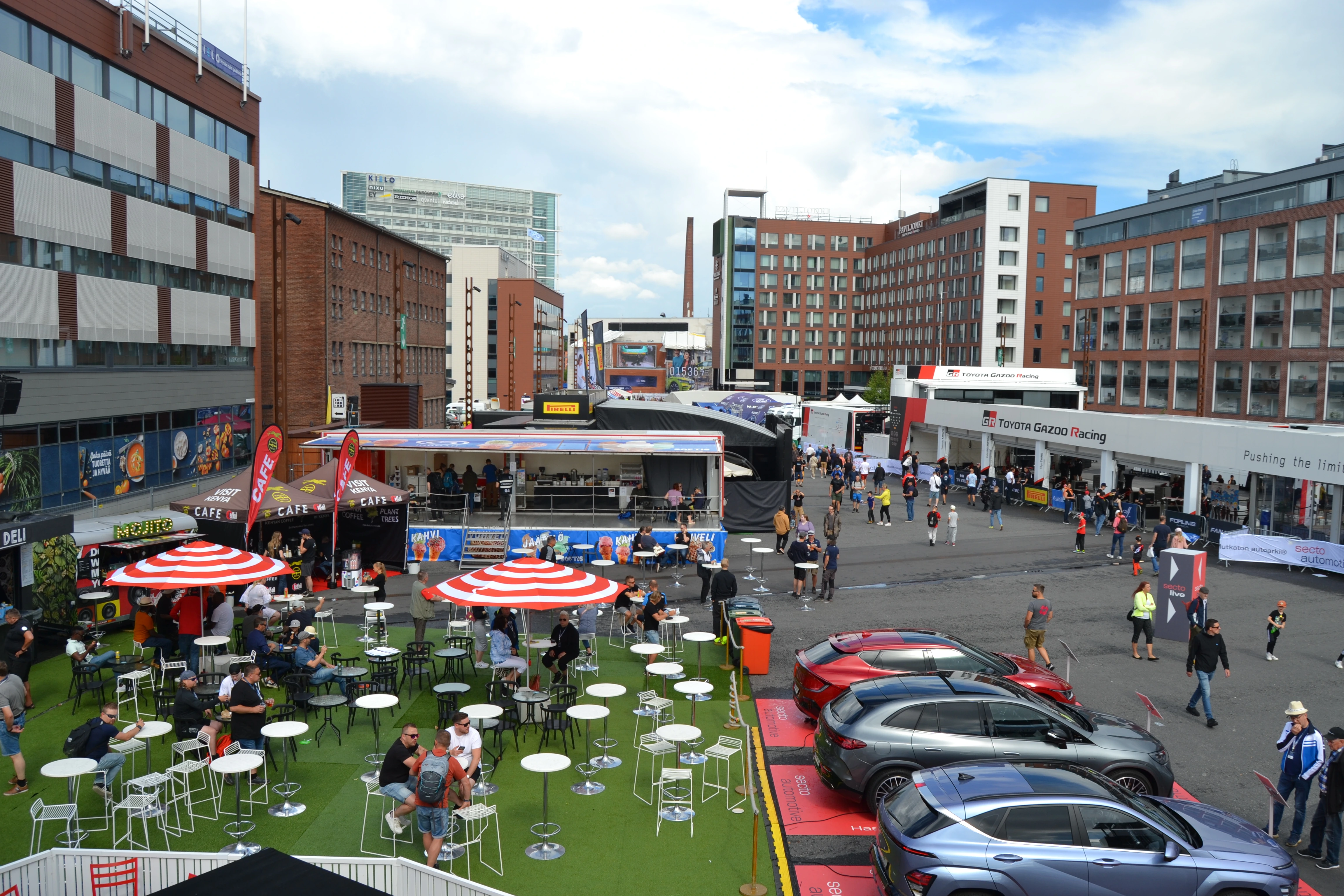 Rally service park with teams working on rally cars